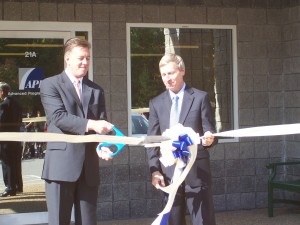 API CEO Steven Rice cuts the ribbon at his company's new Salem, NH facility as Governor John Lynch looks on. 