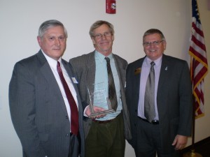 Common Man Owner Alex Ray (center) receives the “Commissioner’s Company of the Year” award from New Hampshire Department of Resources & Economic Development Commissioner George Bald (l.) and New Hampshire Division of Economic Development Interim Director Roy Duddy (r.).